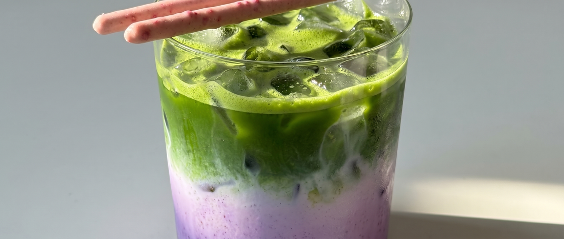 Layered matcha ube latte in a tall glass — green matcha over purple ube milk, served over ice